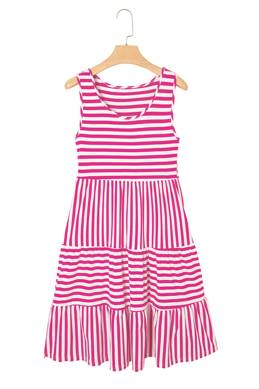 Pink and white striped dress on a hanger against a white background