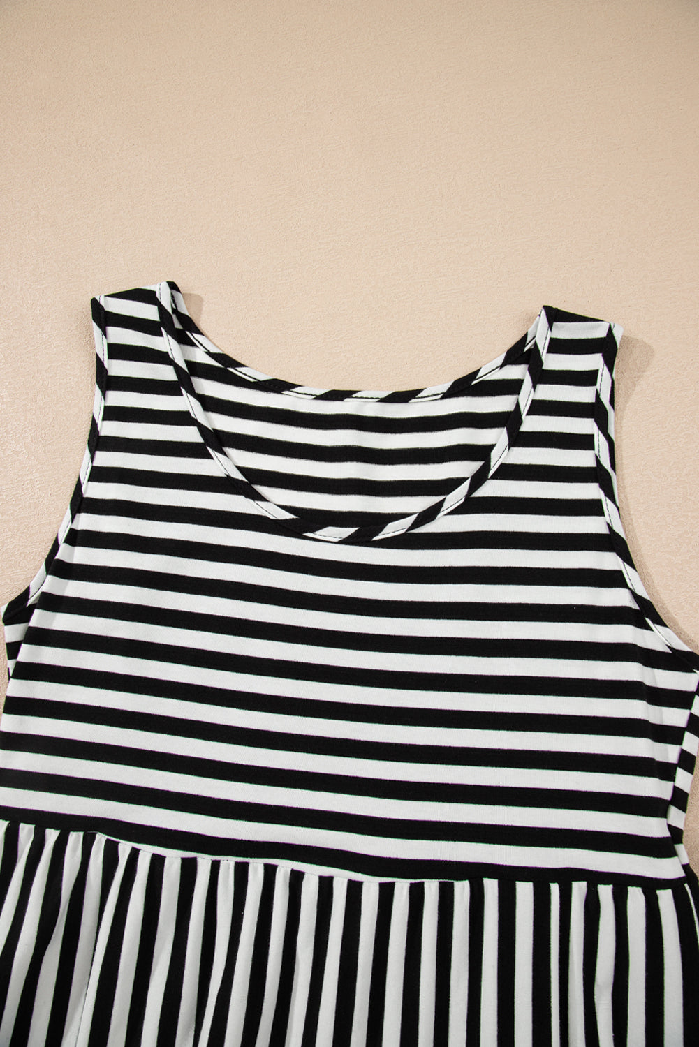 Black and white striped dress on a beige background