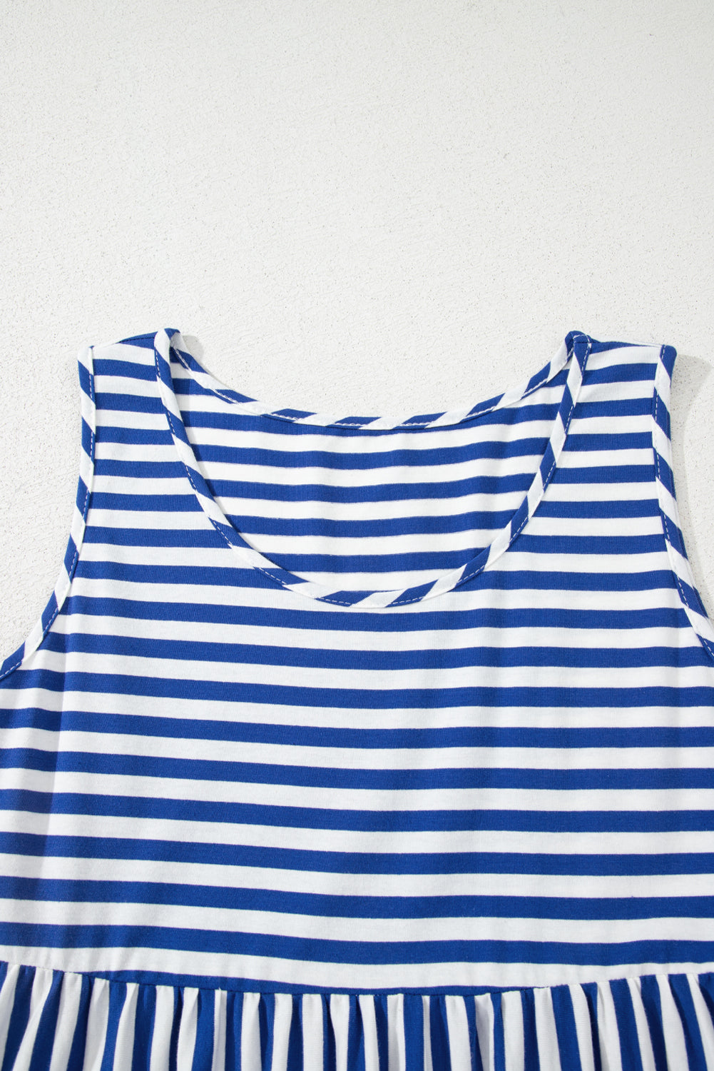 Blue and white striped dress on a white background