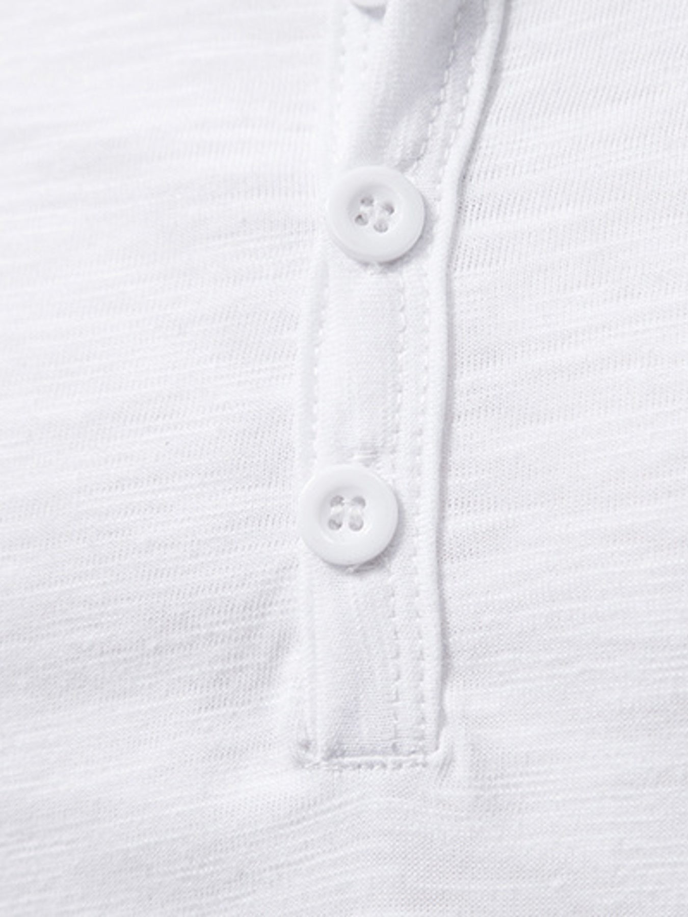 Close-up of a white shirt with buttons on a white background
