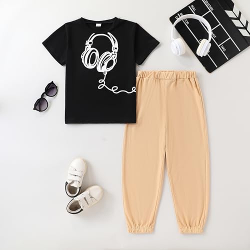 Black t-shirt with headphones design, beige pants, white sneakers, sunglasses, and a clapperboard on a white background