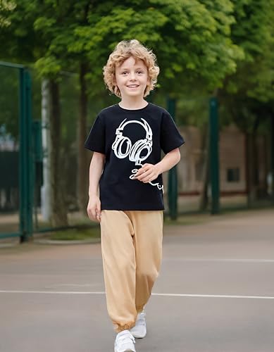Child wearing a black t-shirt with a white graphic design on a sports court.