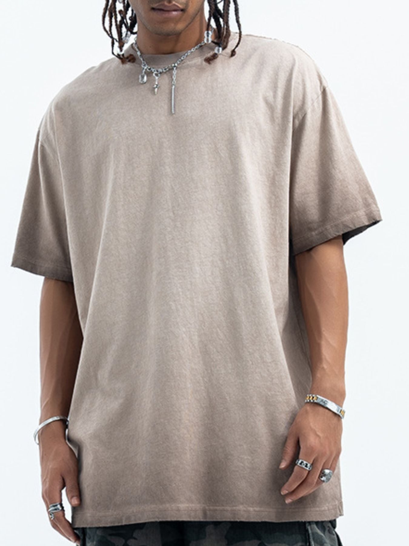 Person wearing a beige t-shirt on a white background