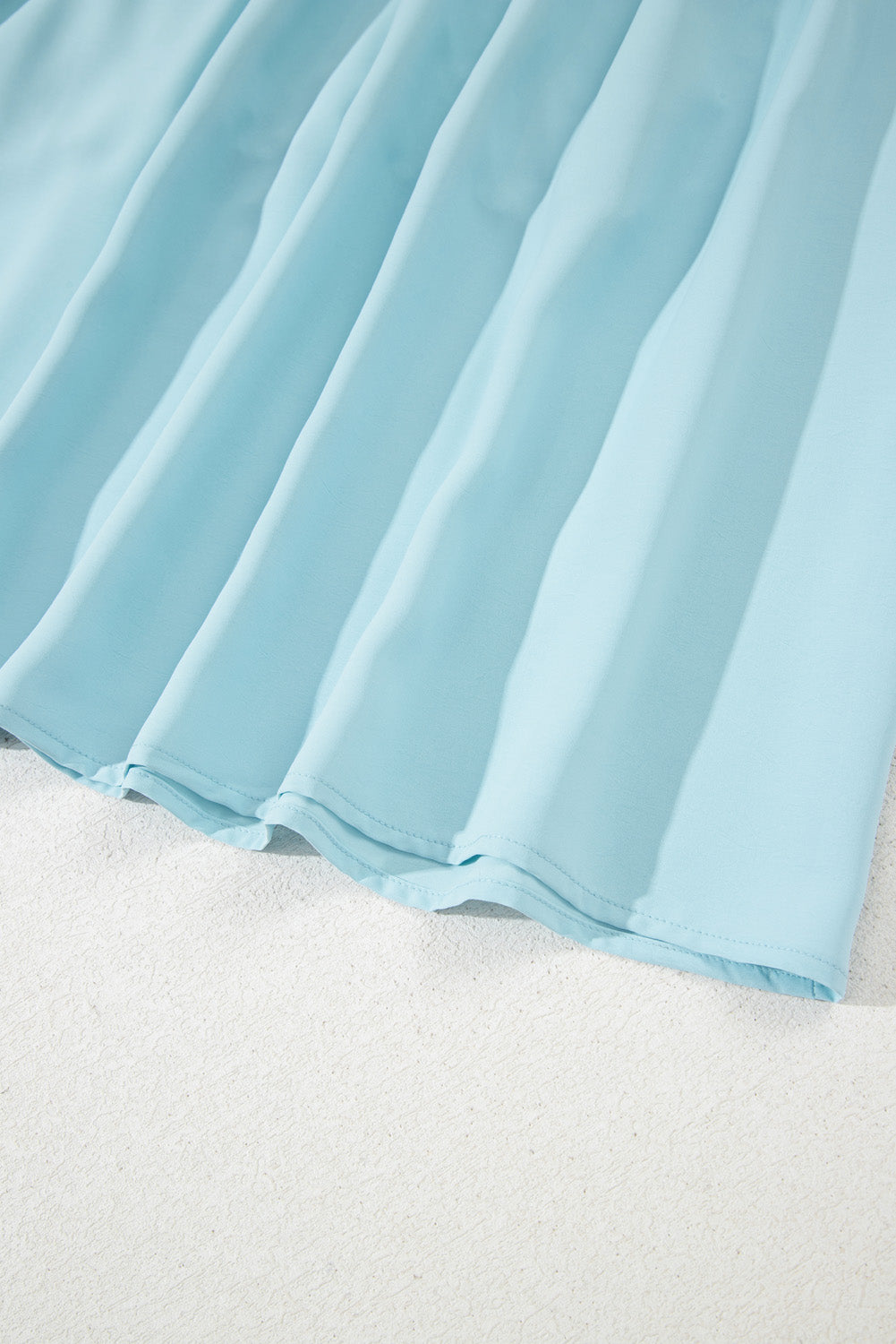 Close-up of light blue fabric on a white background