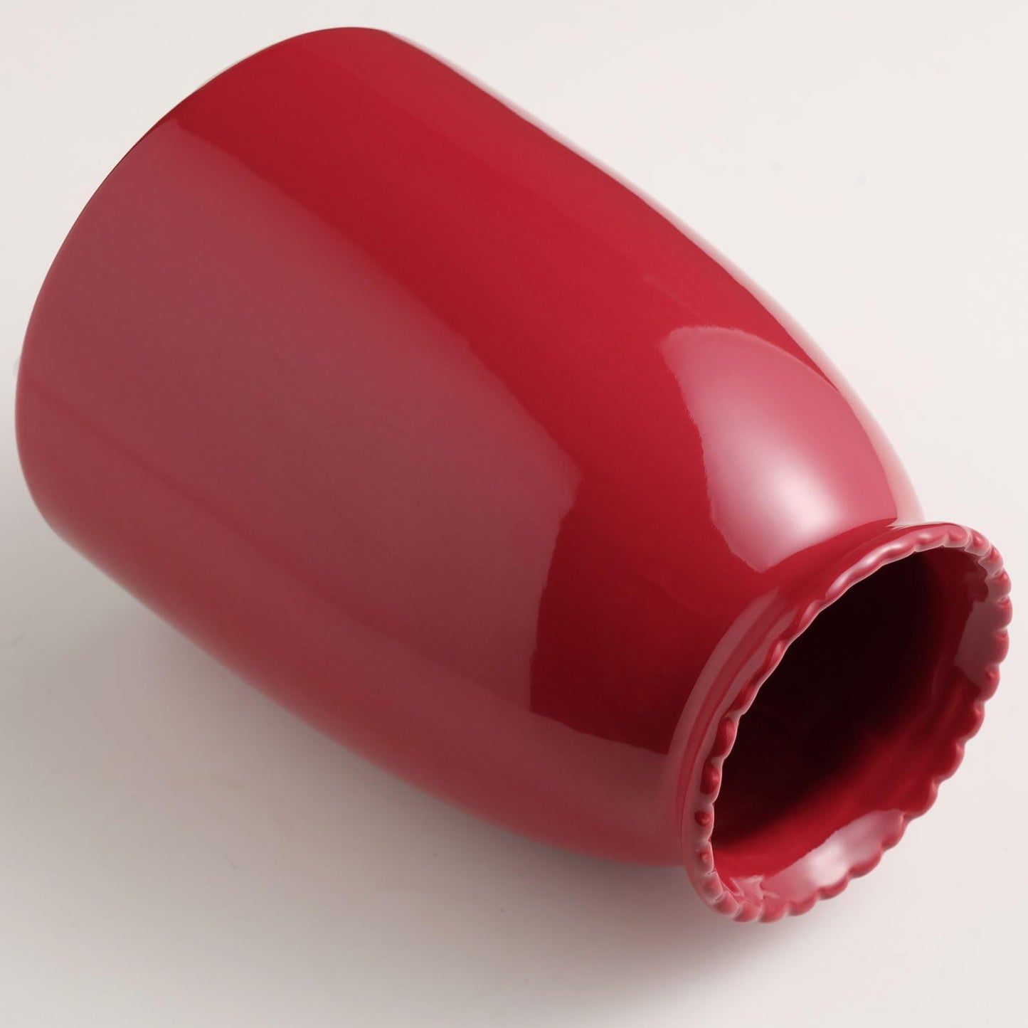 Red plastic component on a white background