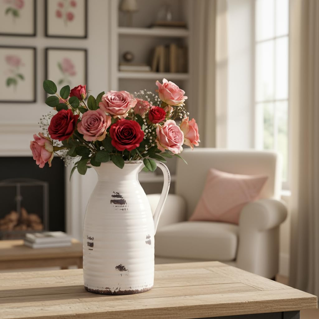 White vase with red and pink roses on a wooden table in a living room.