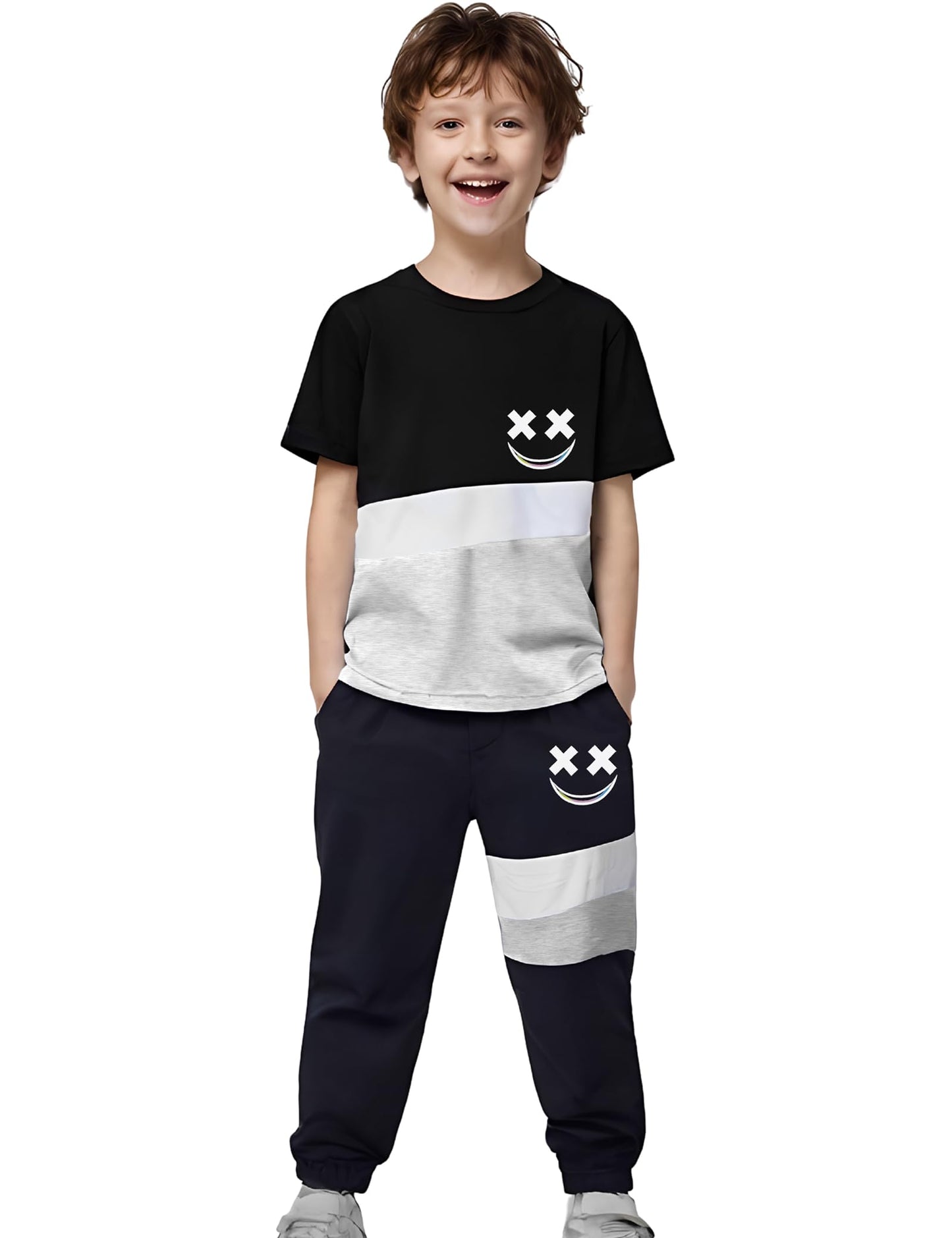 Child wearing a black and white t-shirt and navy jogger pants with smiley face designs on a white background