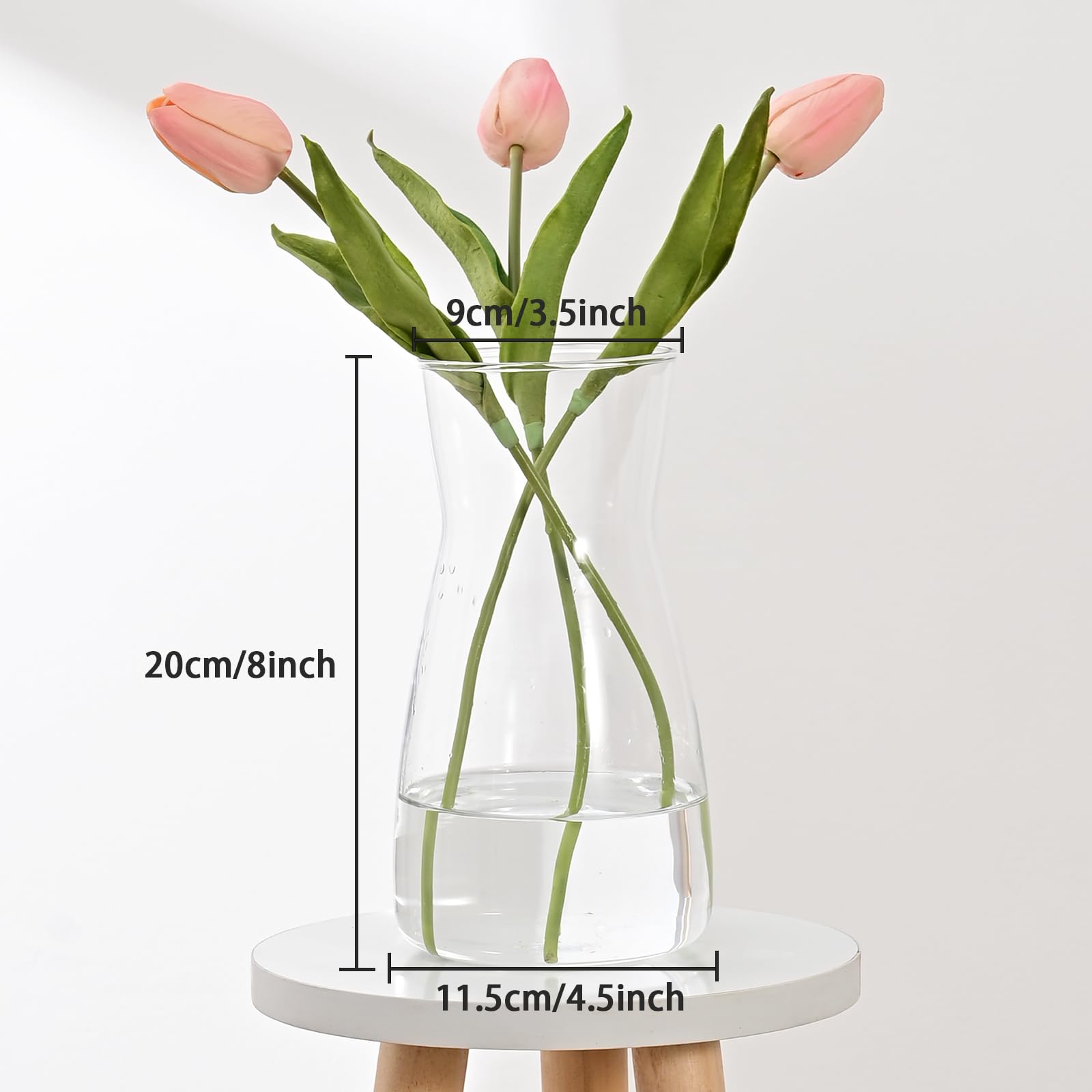 Clear glass vase with pink tulips and measurements on a white background