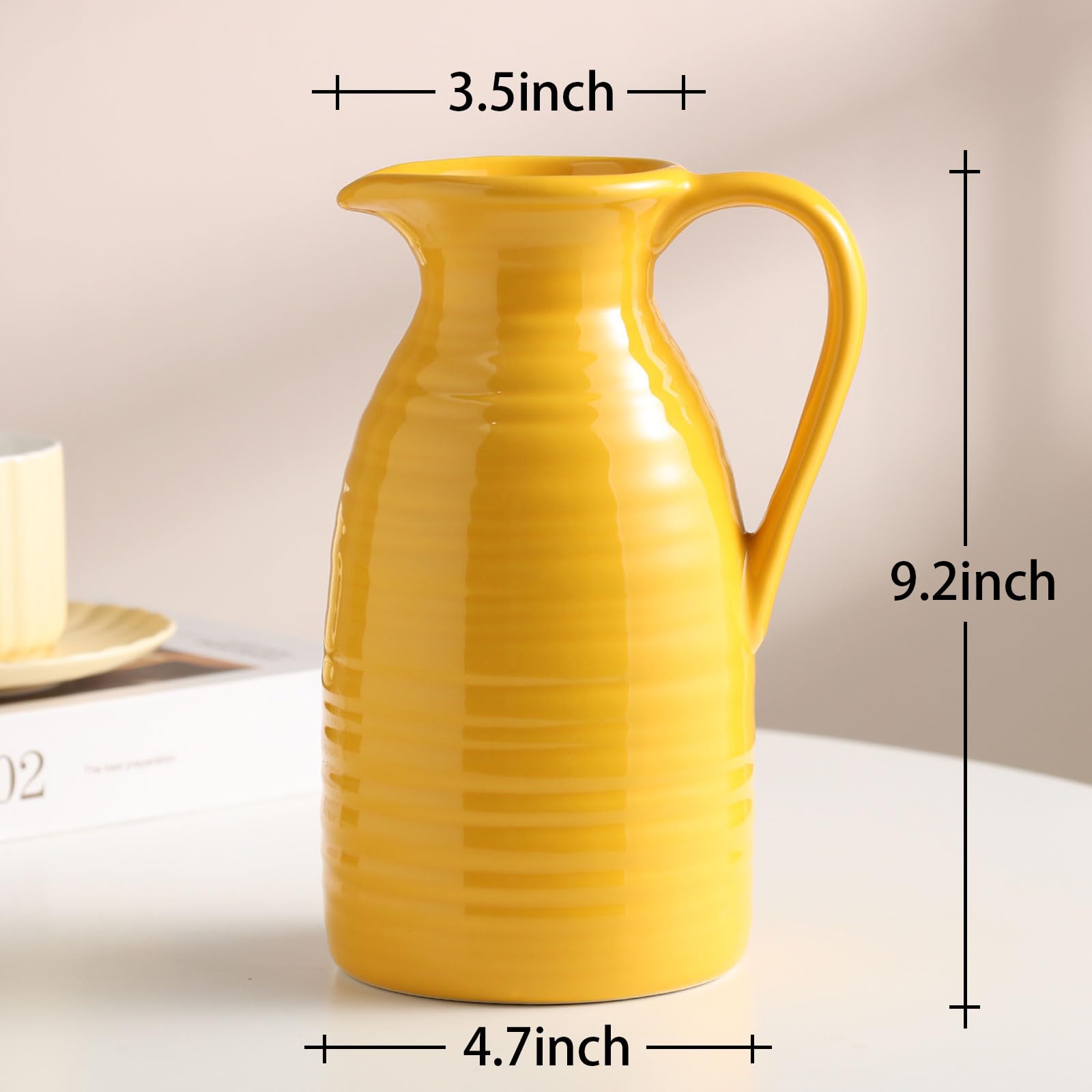 Yellow ceramic pitcher with dimensions labeled on a neutral background