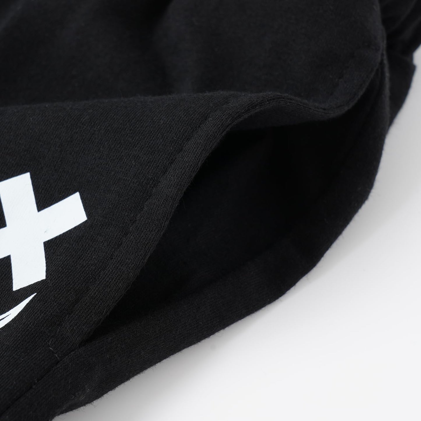 Black fabric with a white logo on a white background