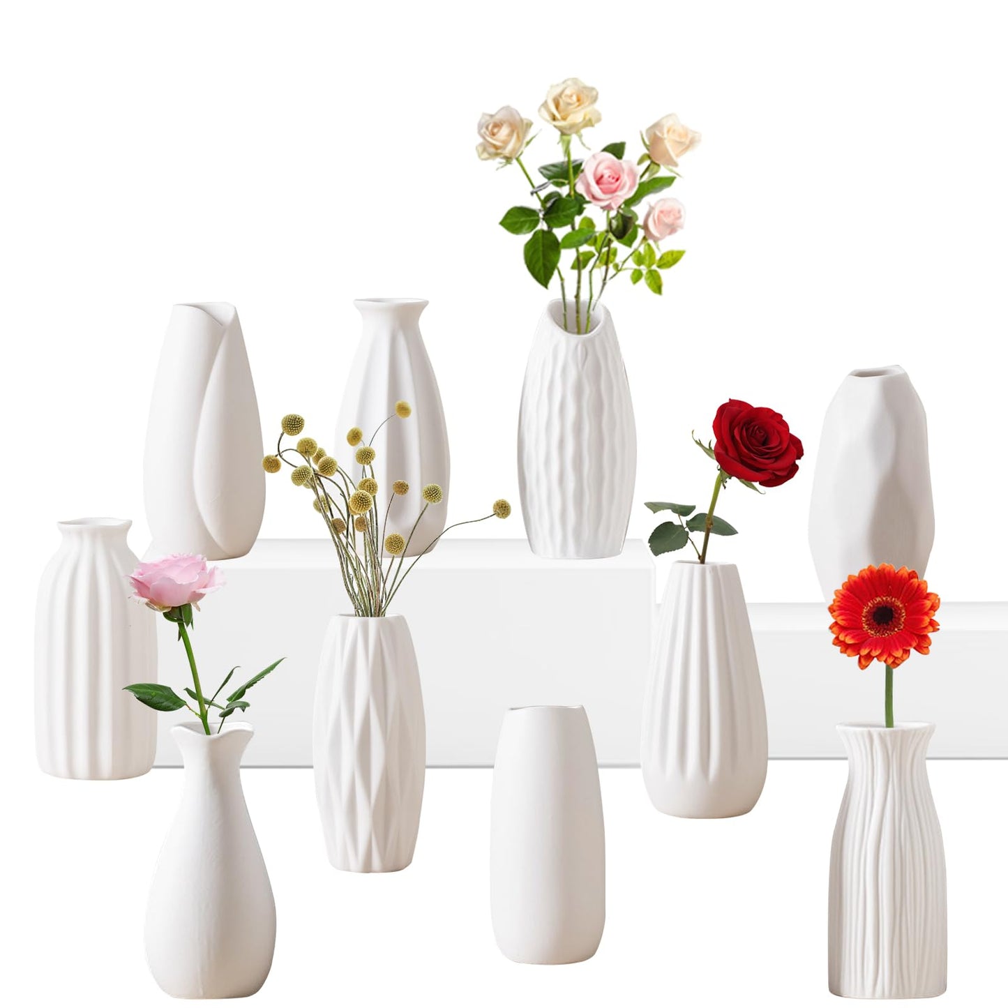 Set of white vases with flowers on a white background