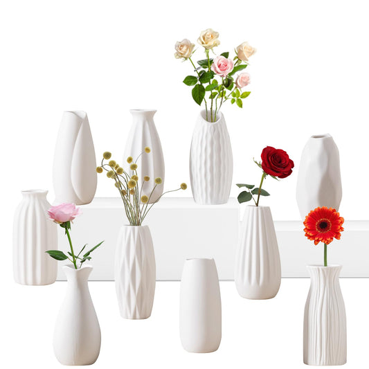 Set of white vases with flowers on a white background