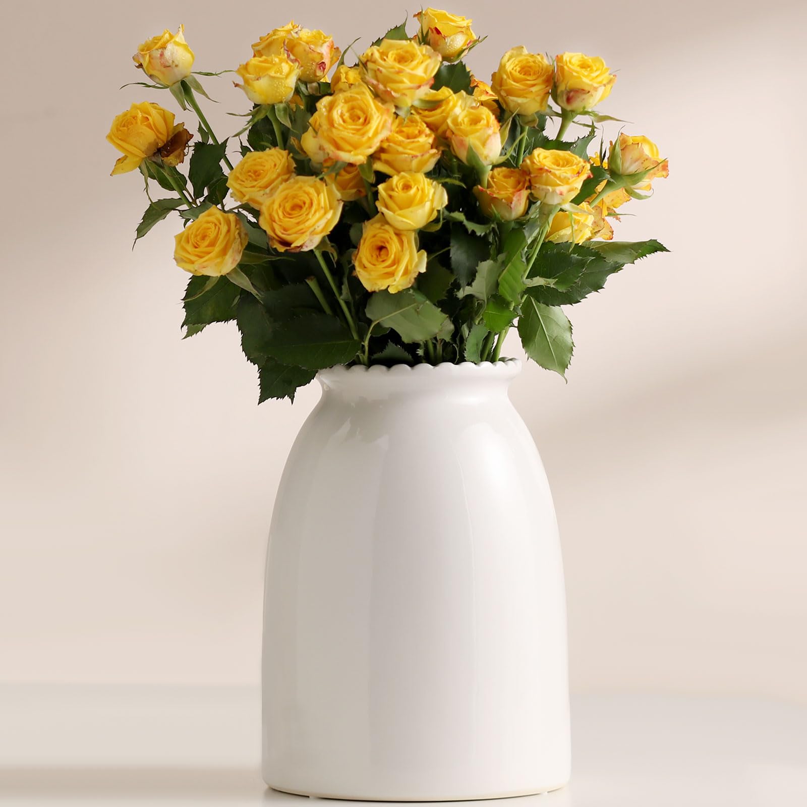Bouquet of yellow roses in a white vase on a light background