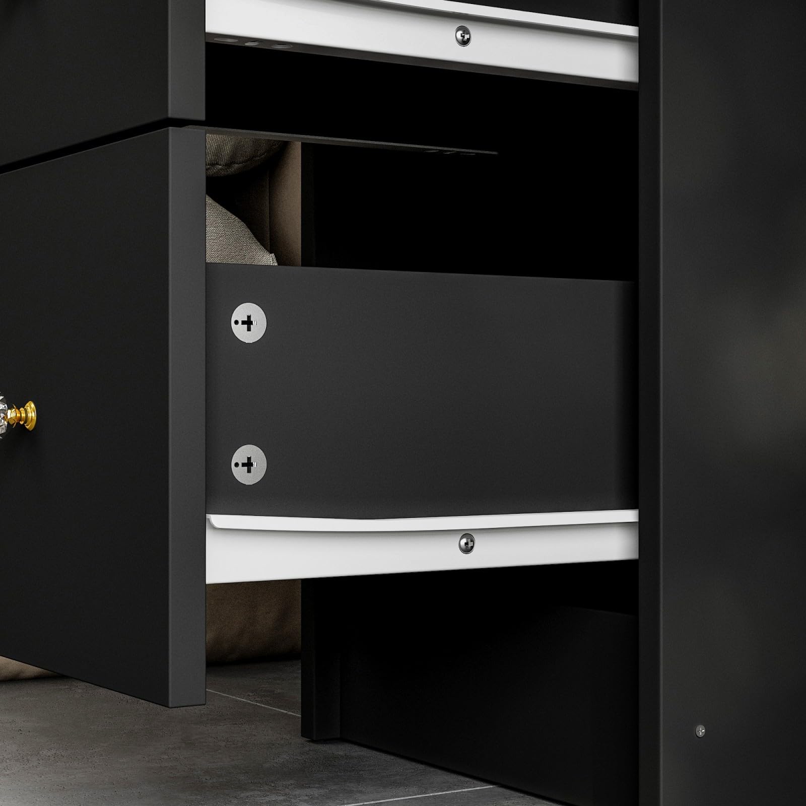 Black cabinet with open drawer on a dark background