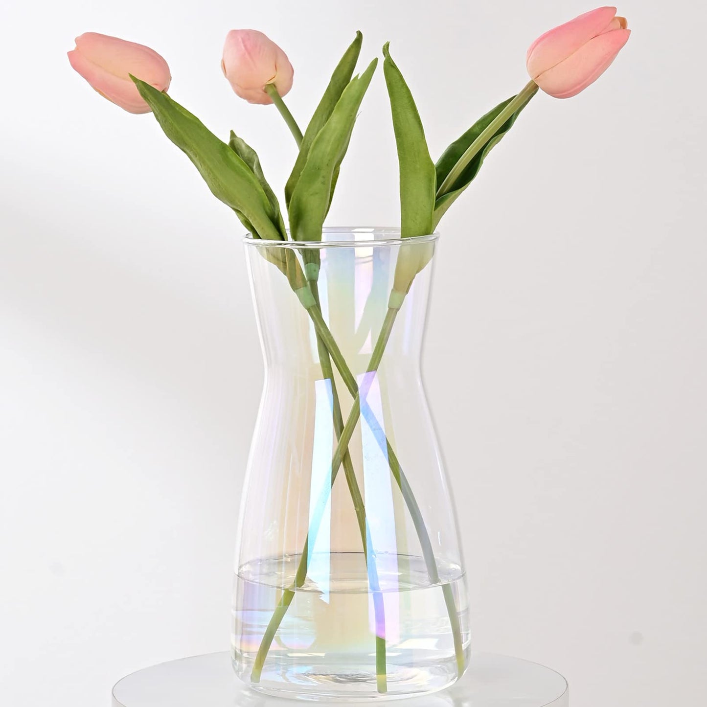 Clear vase with pink tulips on a white background