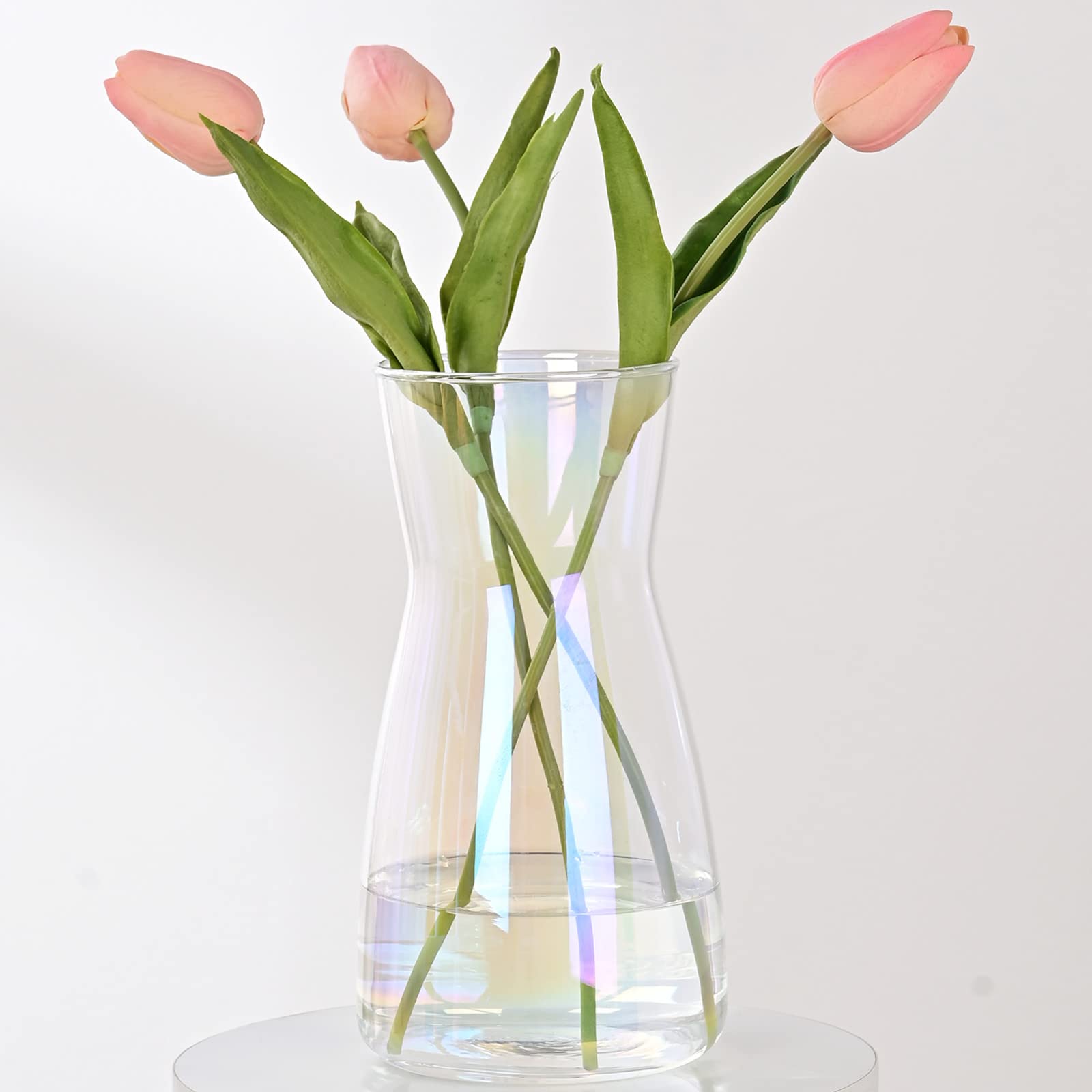 Clear vase with pink tulips on a white background