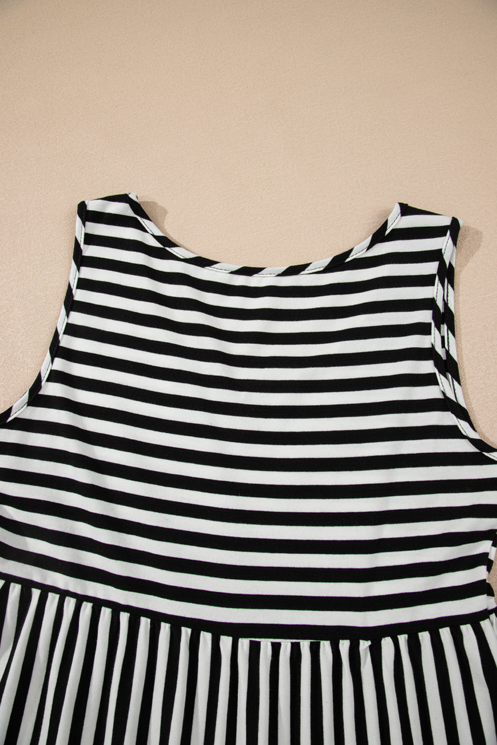 Black and white striped dress on a beige background