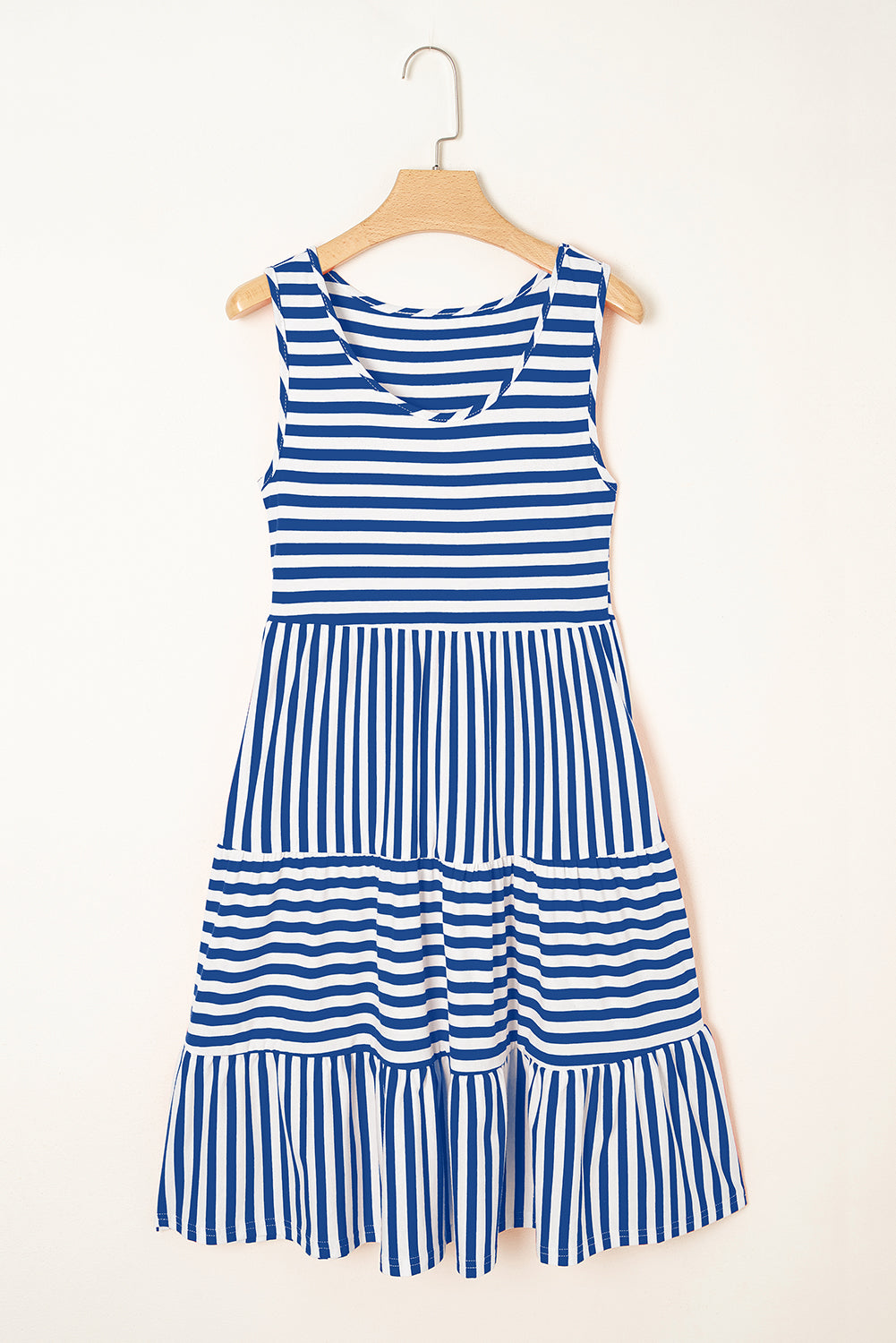 Blue and white striped dress on a hanger against a white background