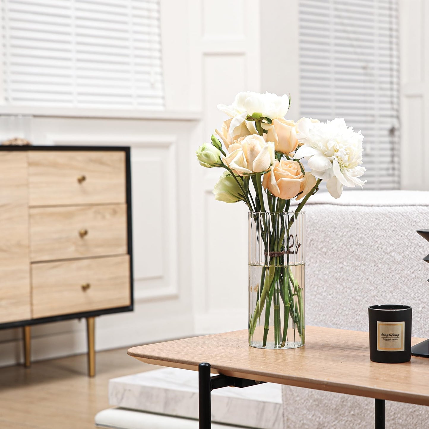 Bouquet of flowers in a vase on a wooden table with a blurred background