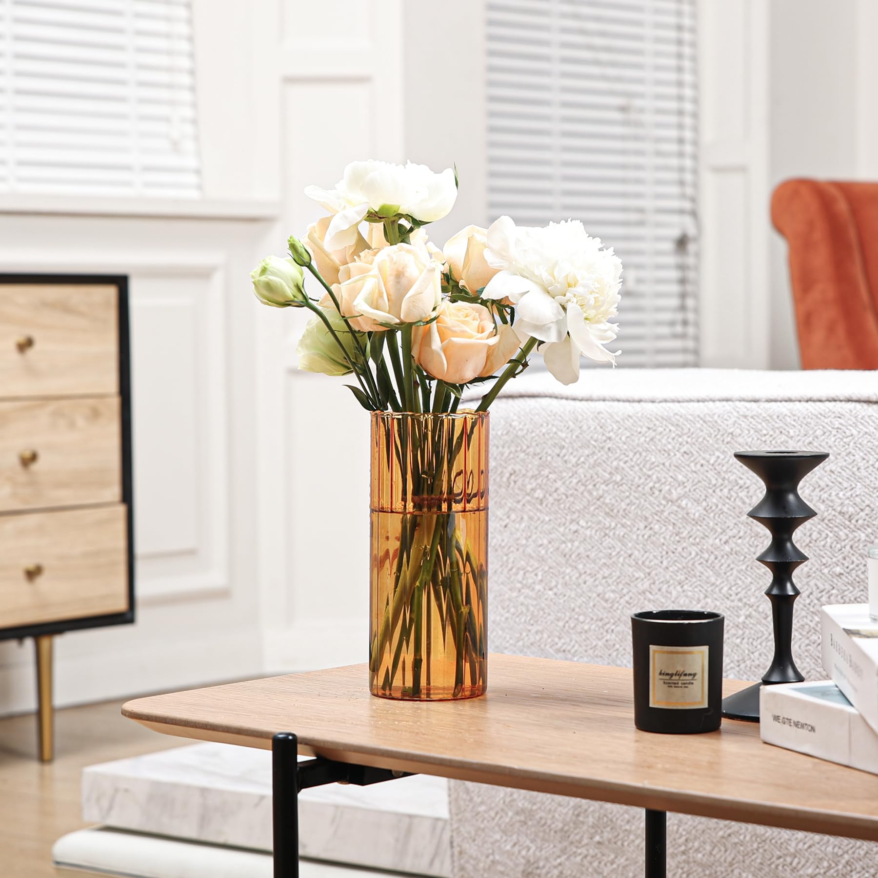 Vase with white flowers on a coffee table in a living room setting