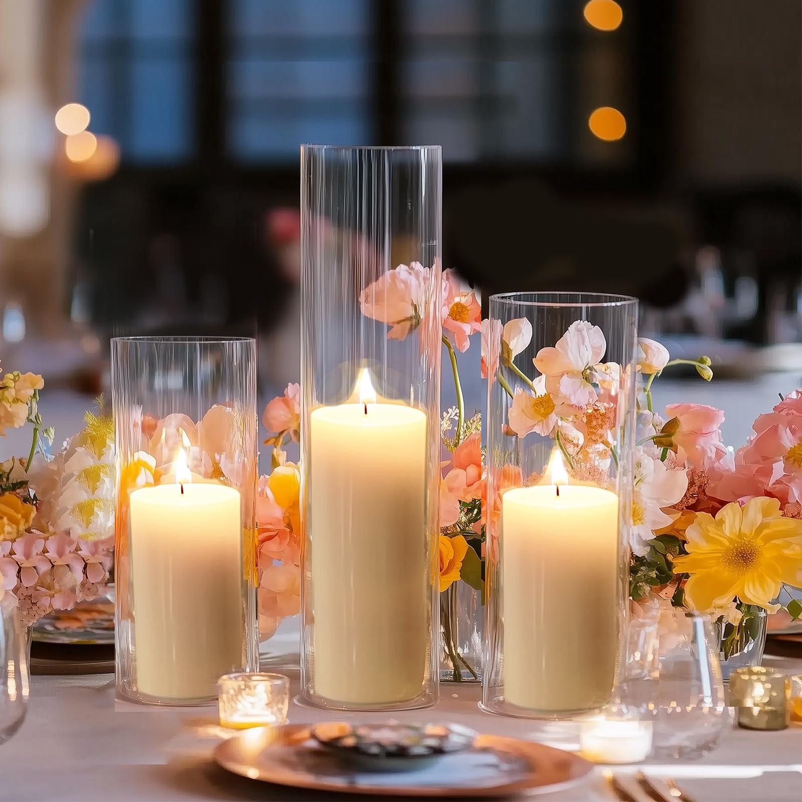 Decorative table setting with candles and flowers in clear glass vases.