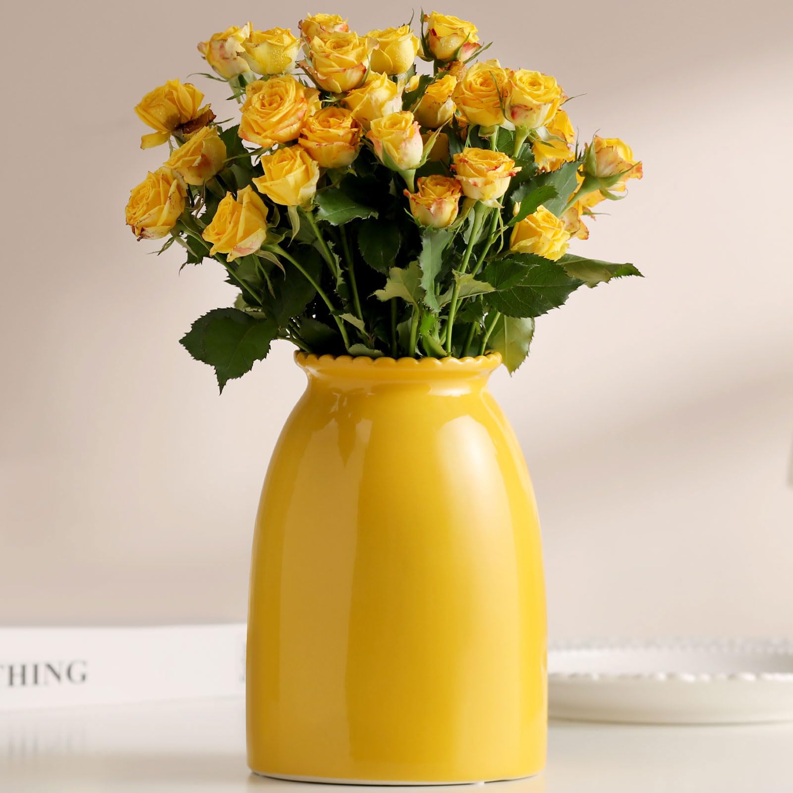 Yellow vase with yellow roses on a light background