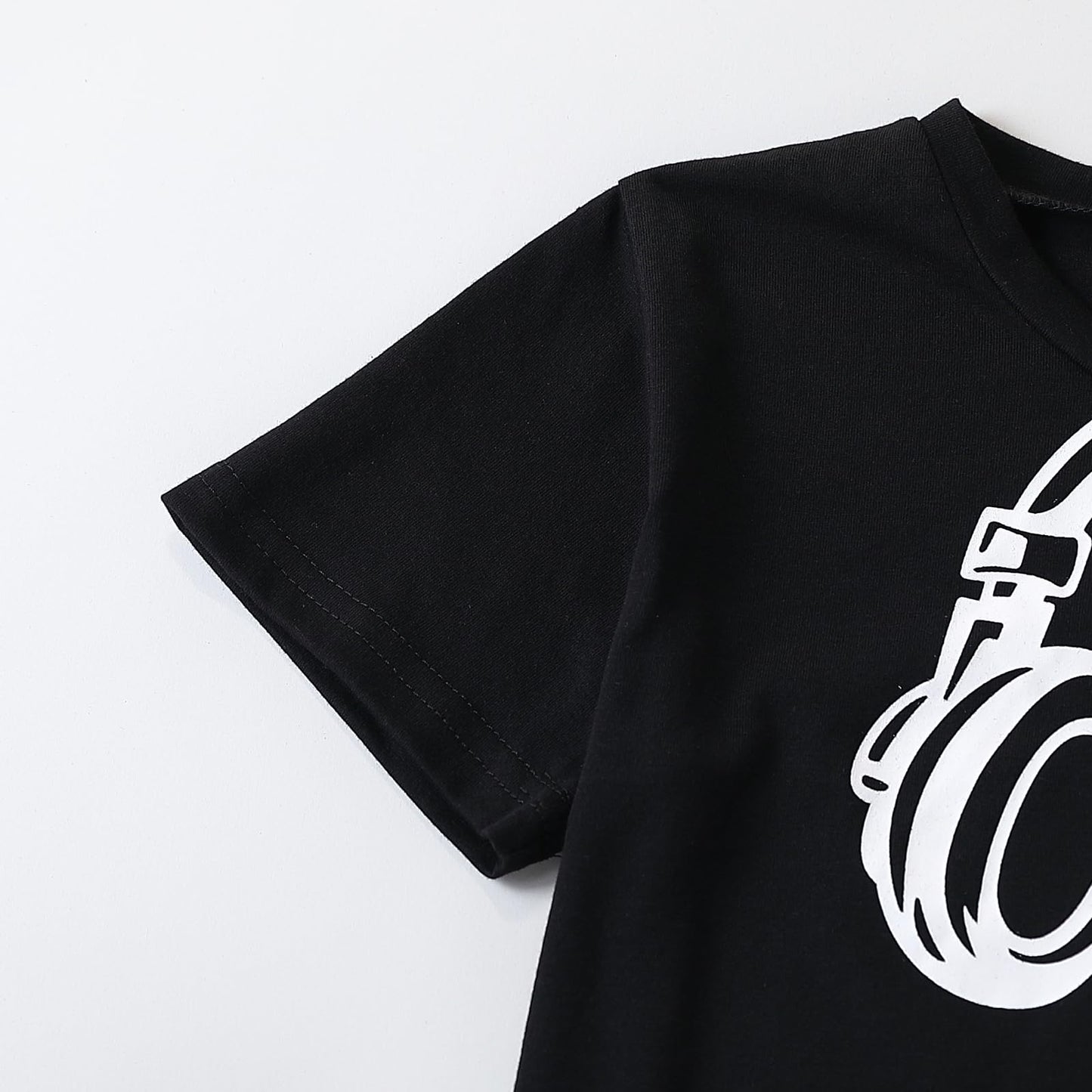 Black t-shirt with a white graphic design on a light gray background