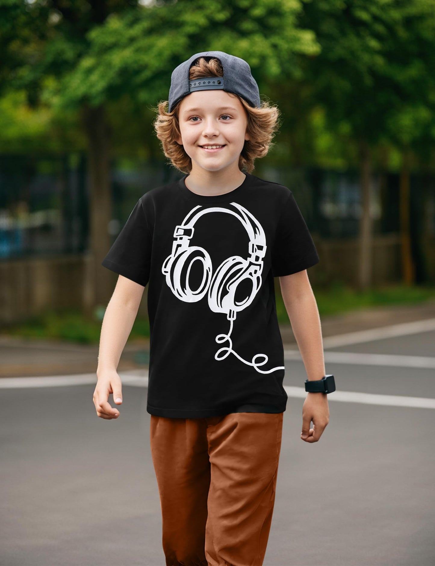 Child wearing a black t-shirt with a white graphic design outdoors