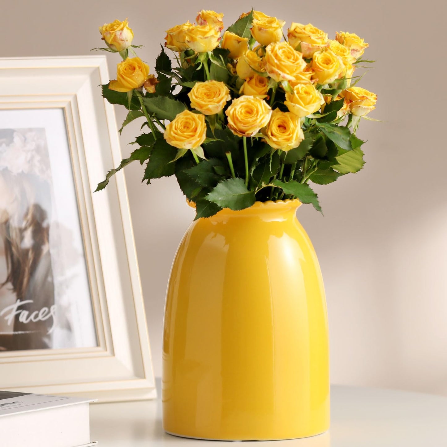 Yellow vase with yellow roses on a neutral background