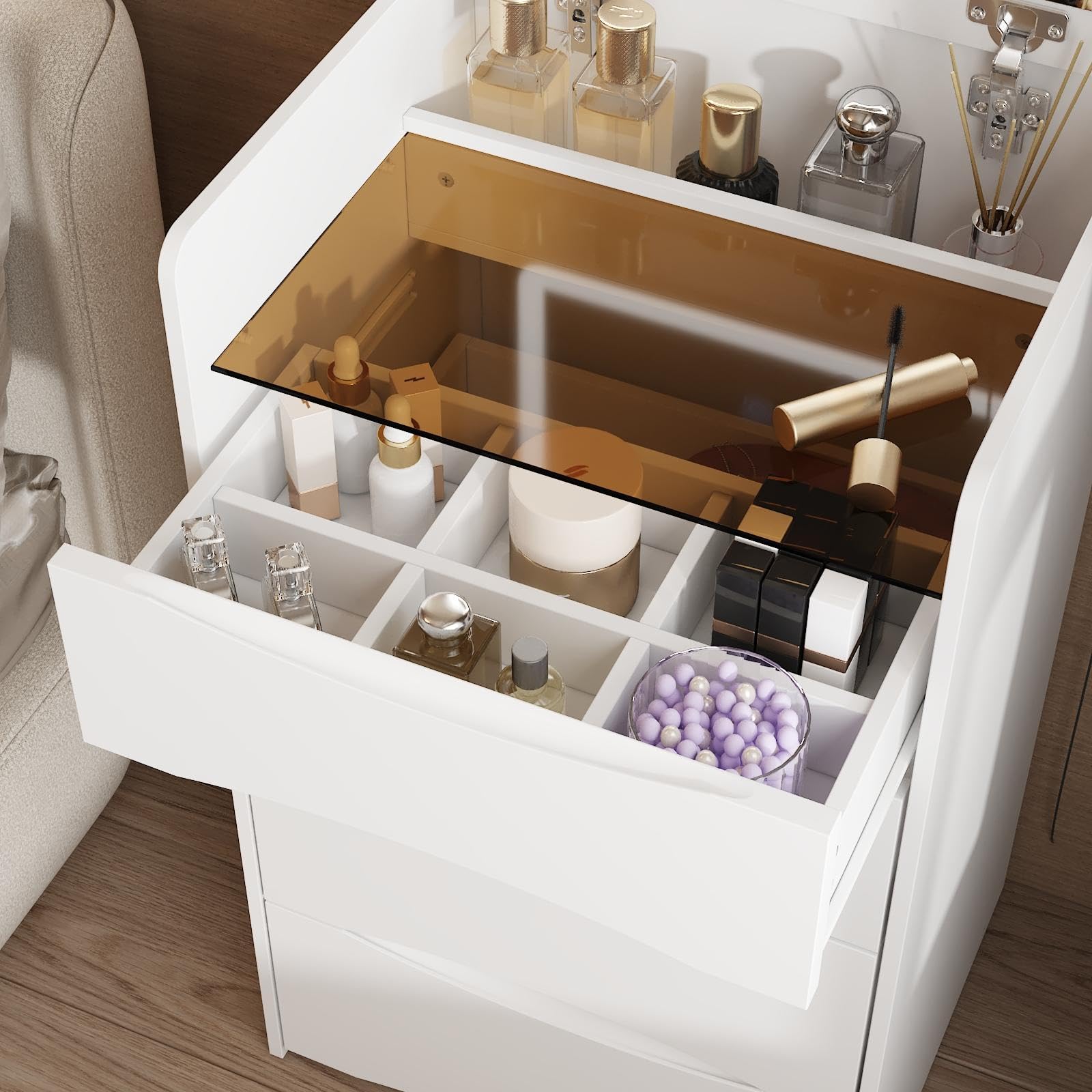 Open drawer with various cosmetic items on a wooden floor.