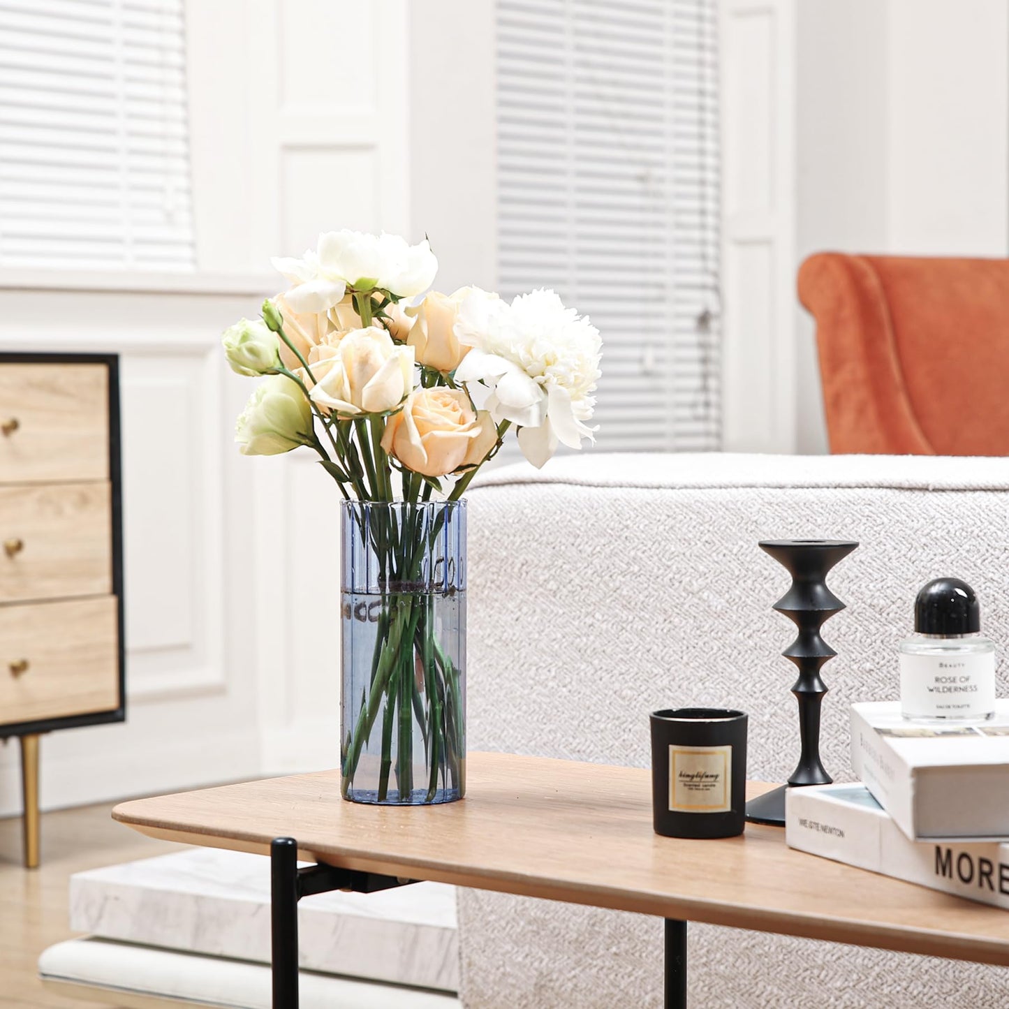 Vase with flowers on a coffee table in a living room setting