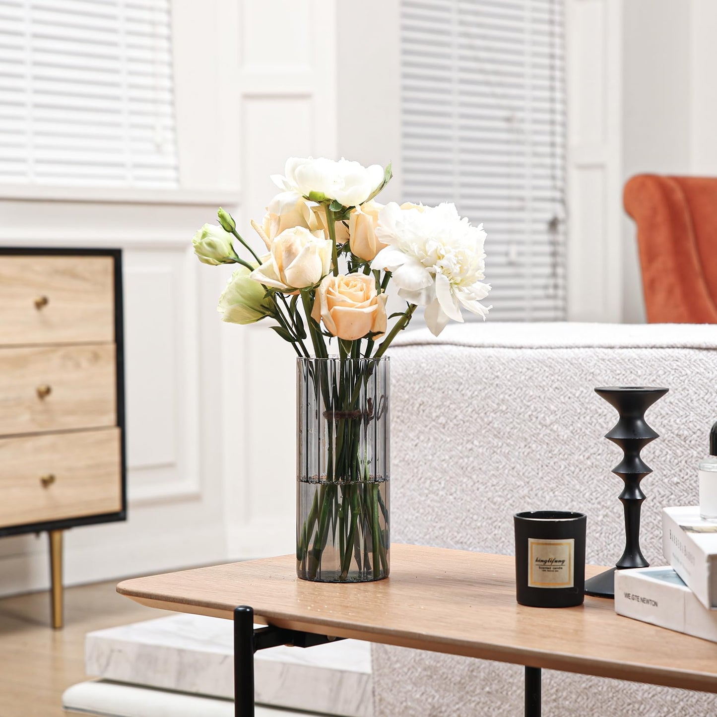 Vase with flowers on a coffee table in a living room setting