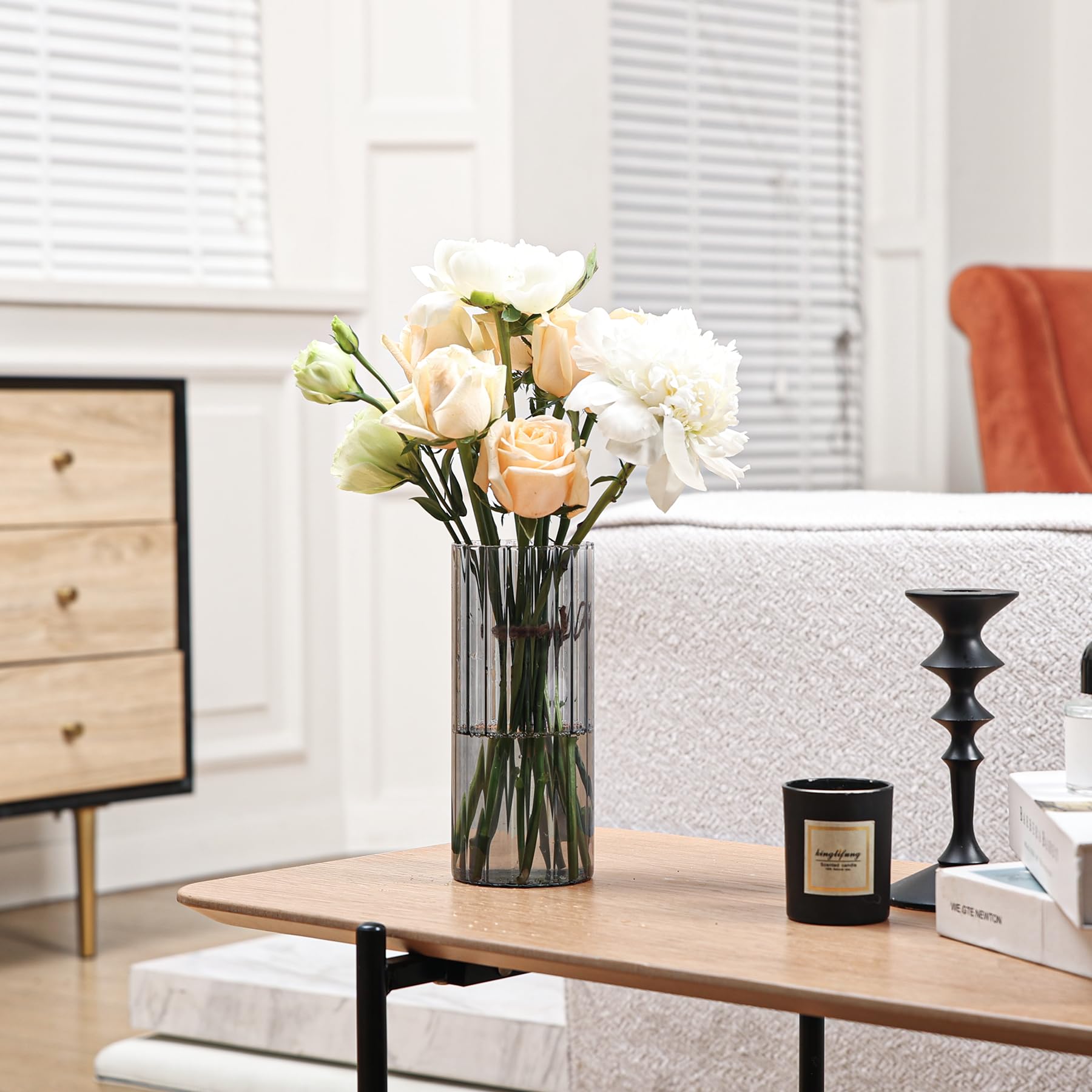 Vase with flowers on a coffee table in a living room setting