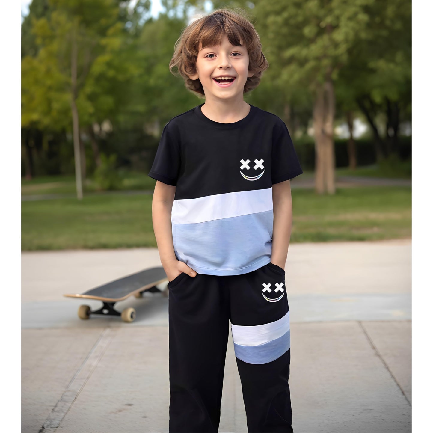 Child wearing a black and blue outfit with smiley face designs, standing outdoors.