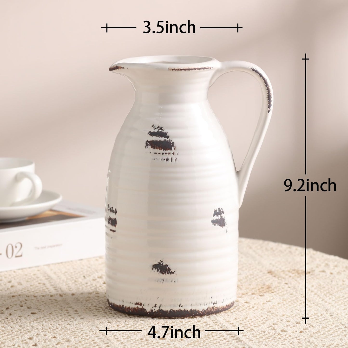 White ceramic pitcher with black designs on a textured surface, shown with measurements.