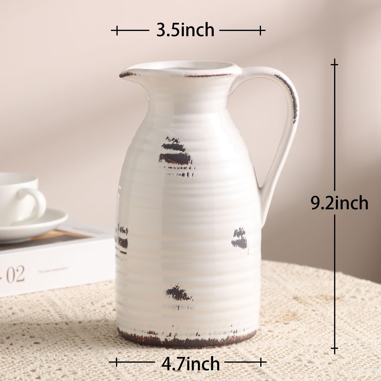 White ceramic pitcher with black designs on a textured surface, shown with measurements.