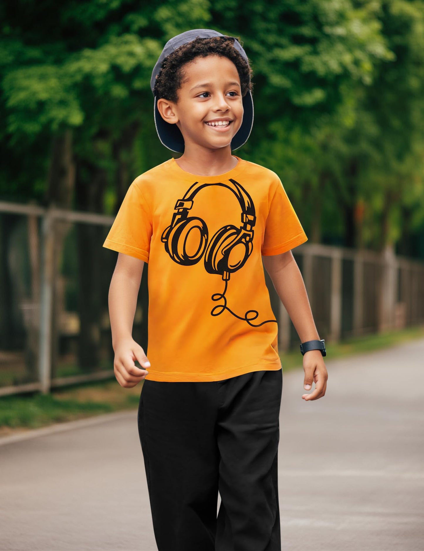 Child wearing an orange t-shirt with a graphic design outdoors