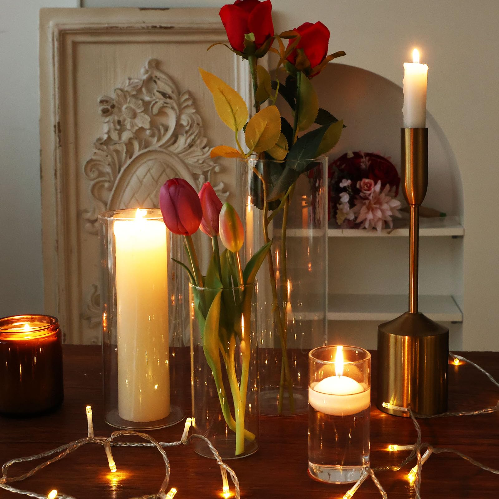Decorative setup with candles and flowers on a table.