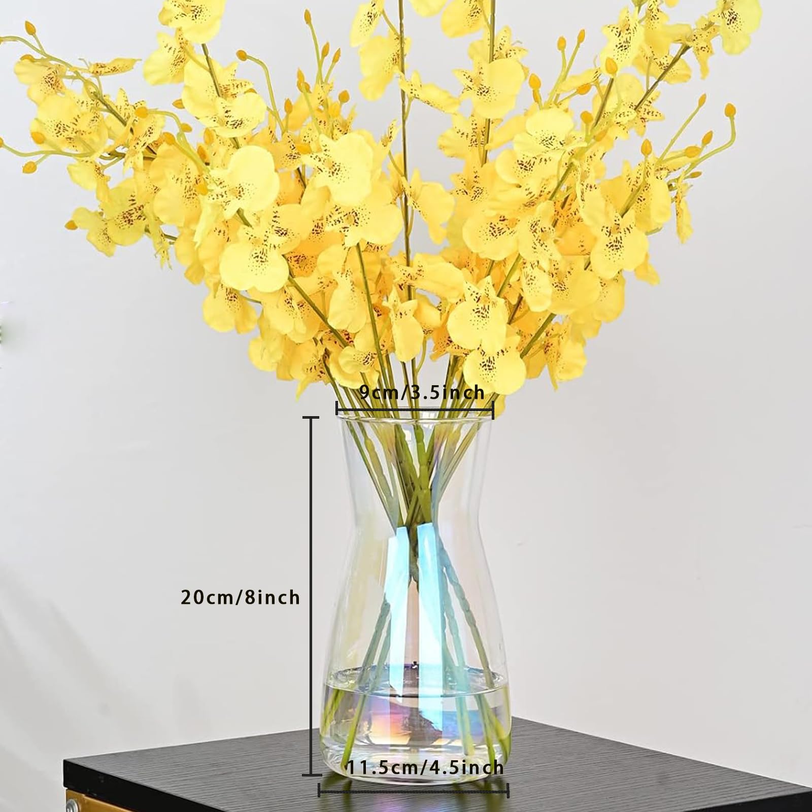 Yellow flowers in a clear vase with measurements on a white background
