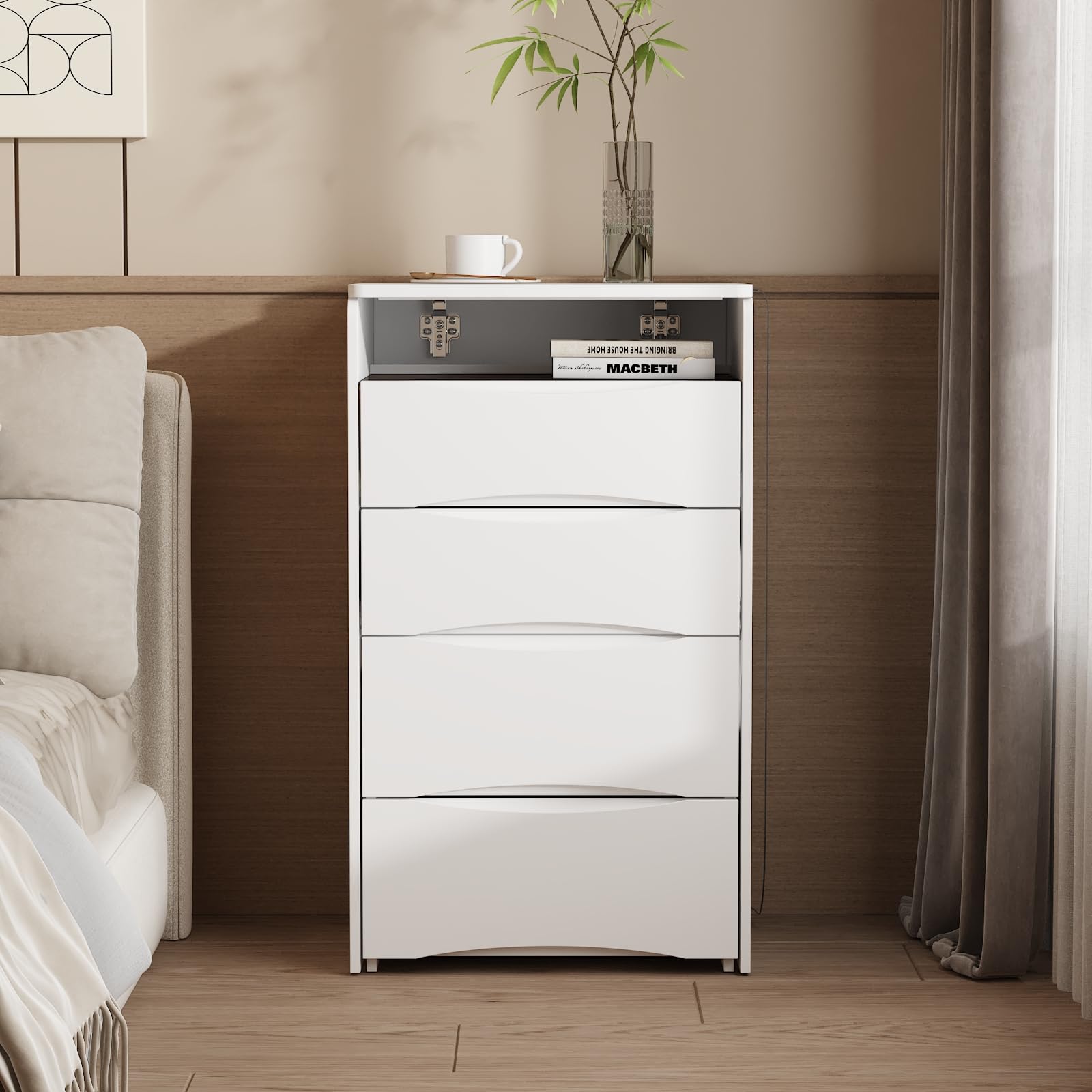 White dresser with books and a plant in a bedroom setting