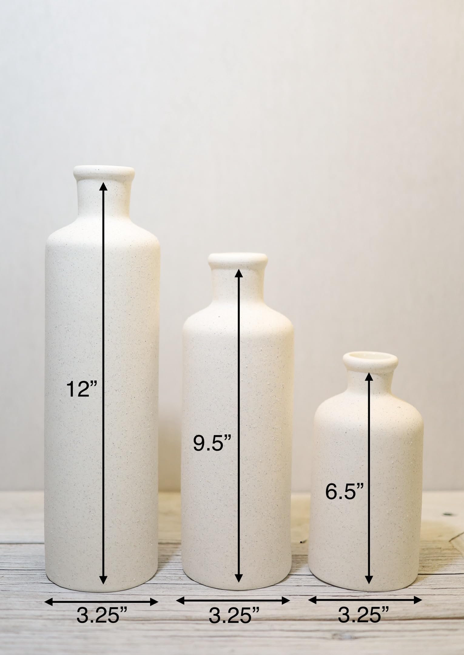 Three white vases of different sizes with measurements on a white background