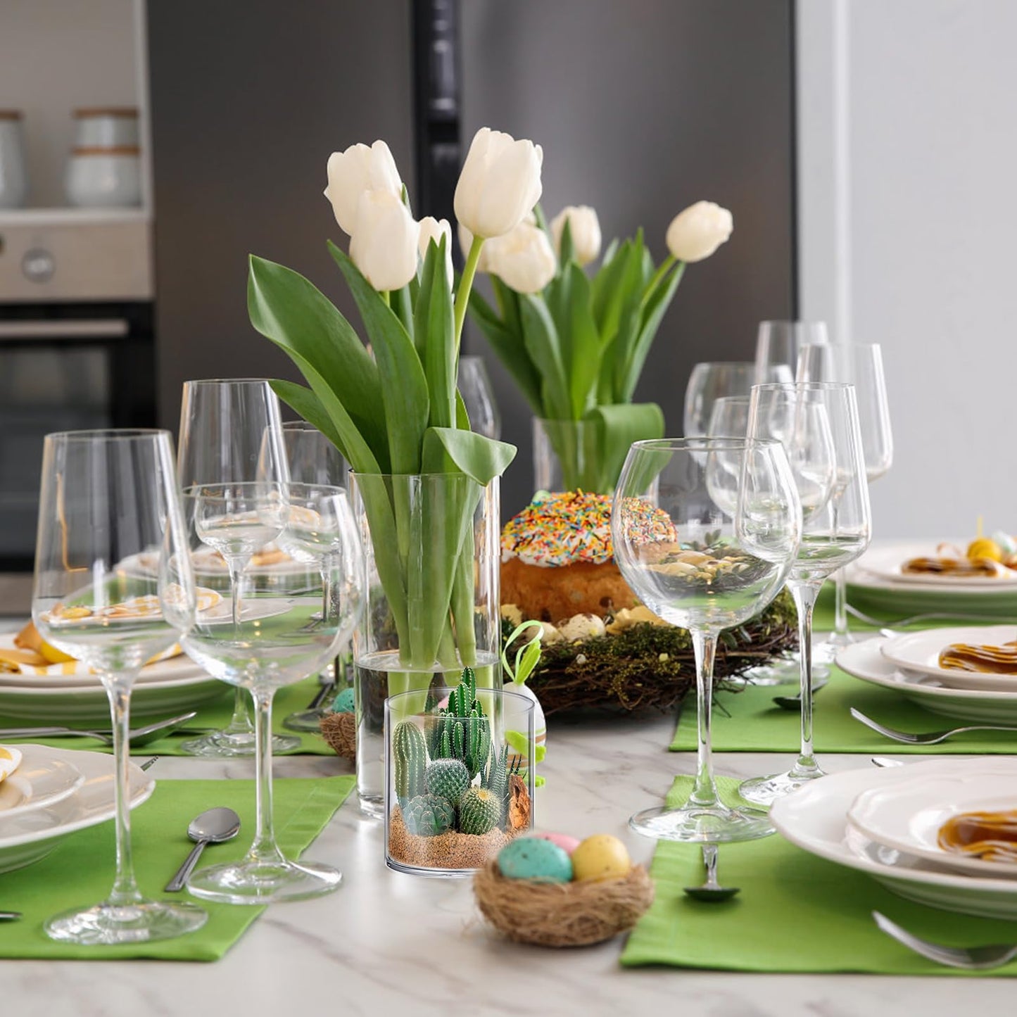 Easter table setting with white tulips, green placemats, and decorative eggs.