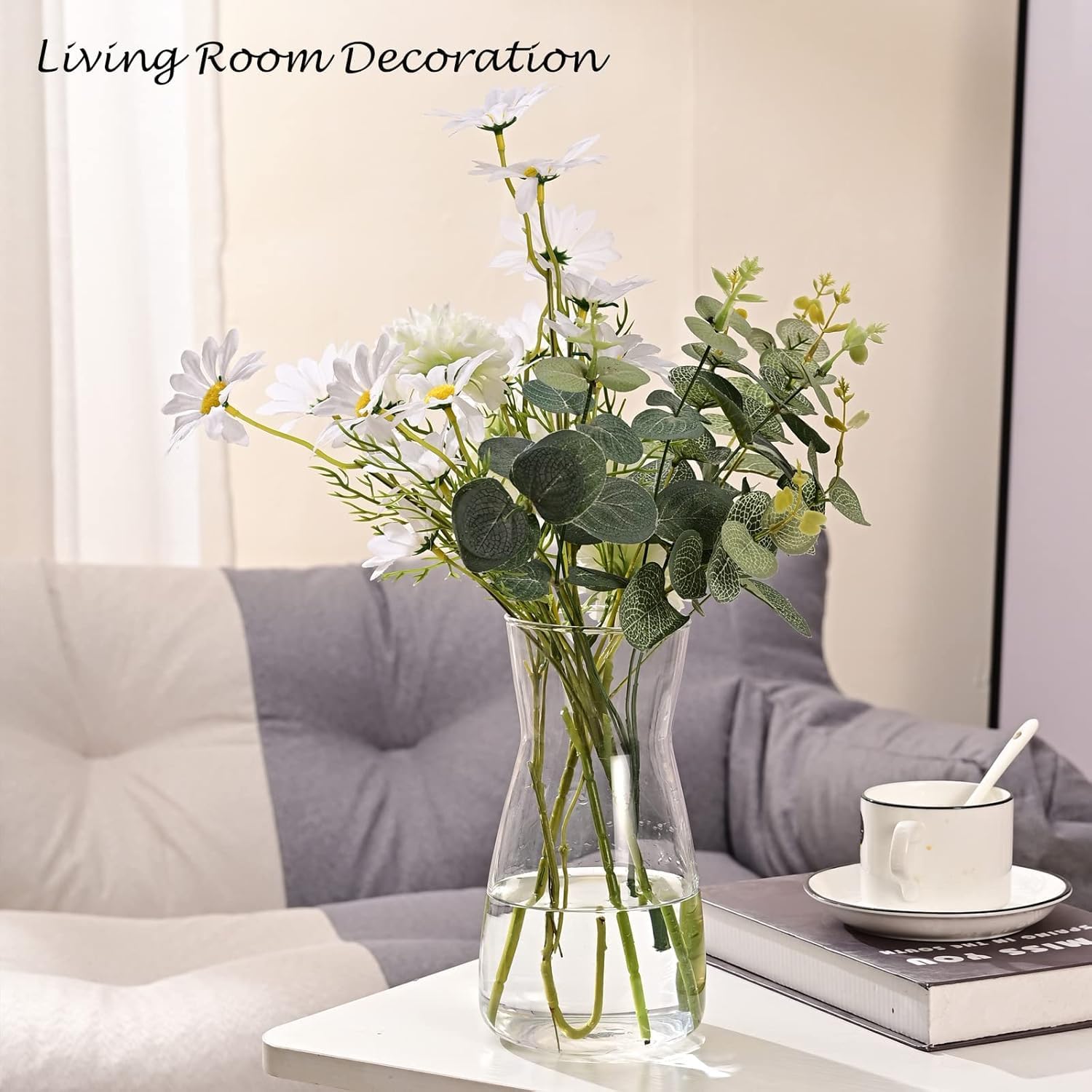 Vase with flowers on a coffee table in a living room setting