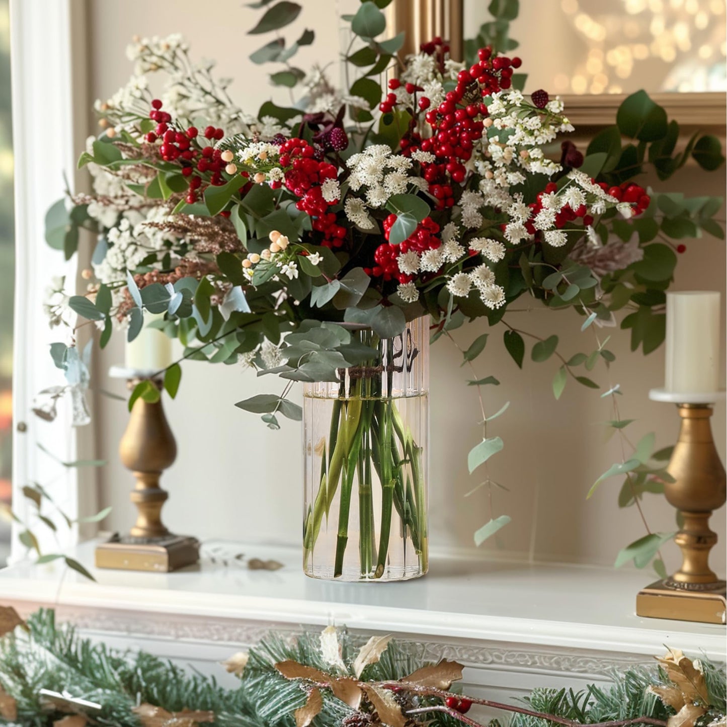 Decorative floral arrangement with red berries and white flowers in a clear vase on a mantelpiece.