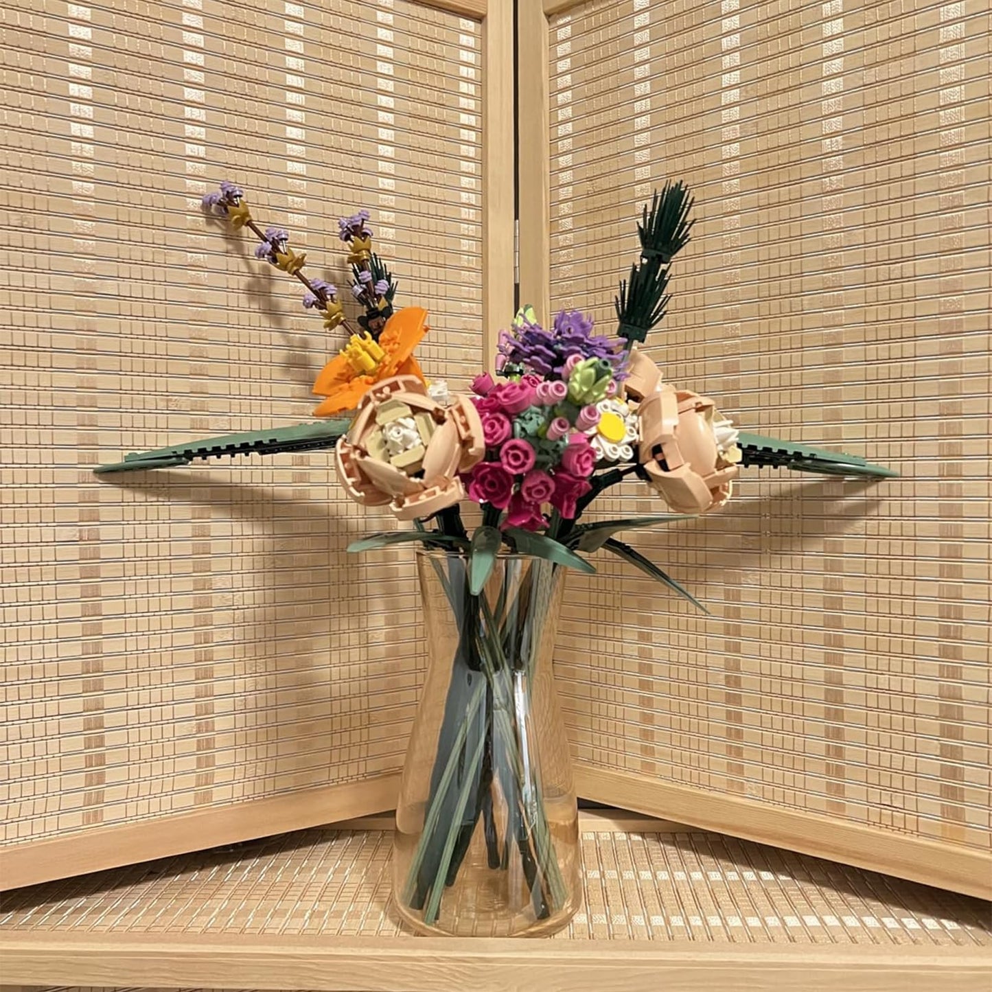 Decorative vase with flowers against a woven wall