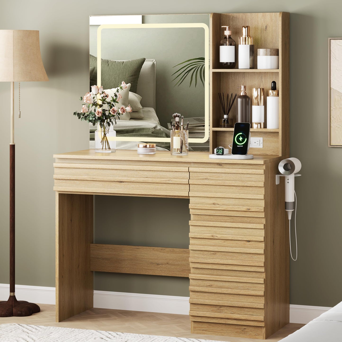 Wooden vanity table with mirror, lamp, and various items in a room.