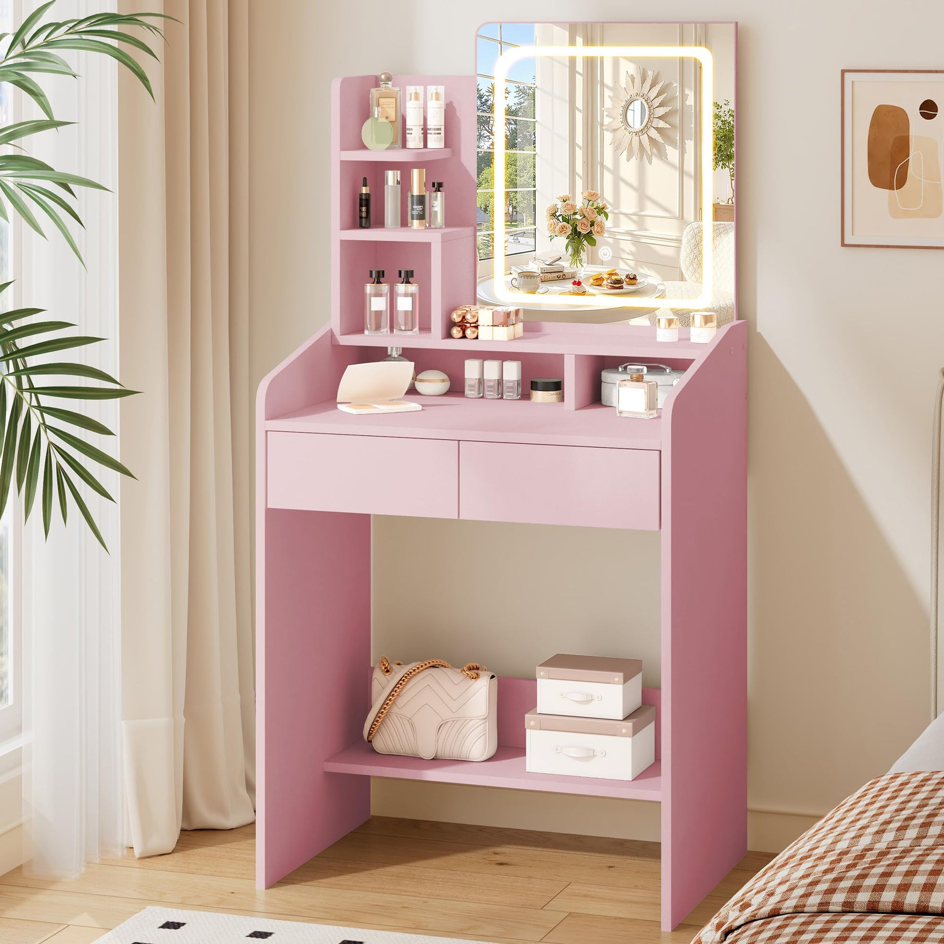 Pink vanity table with mirror and various items in a room setting.