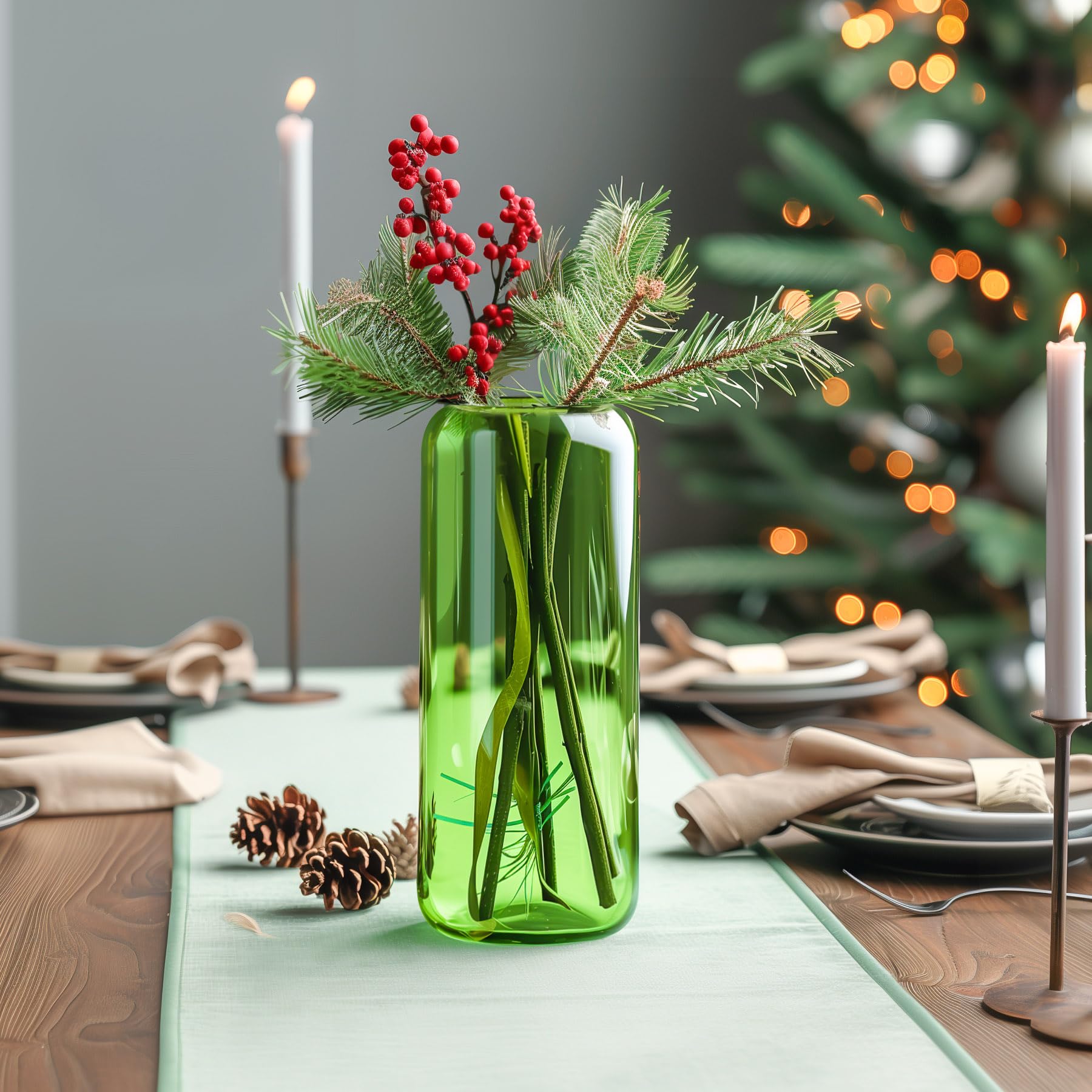 Decorative arrangement with red berries, green leaves, and a vase on a surface.