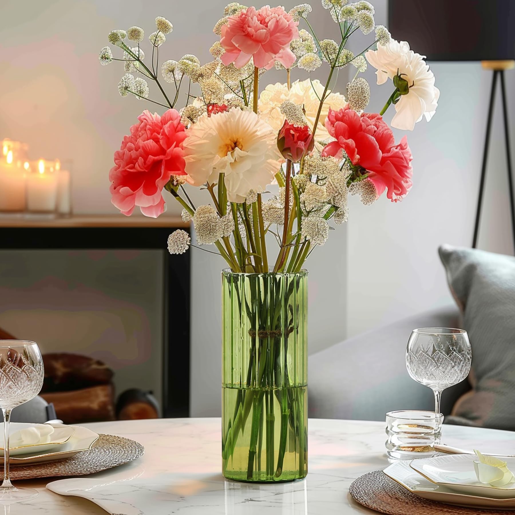 Decorative arrangement with red berries, green leaves, and a vase on a surface.