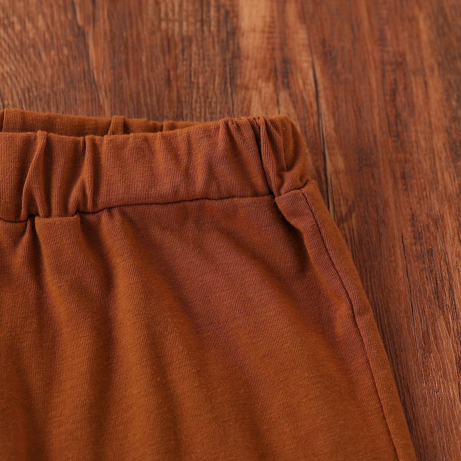 Brown pants on a wooden surface